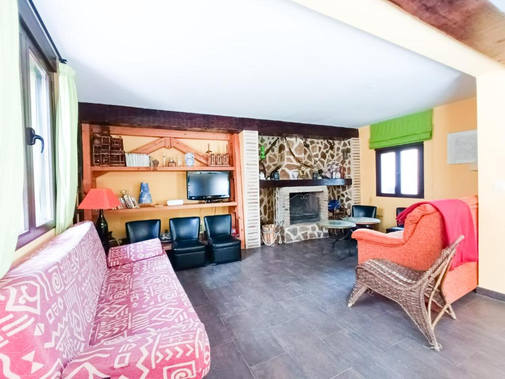 a living room with a couch and a fireplace at Casa rural La Antigua Herrería in Arandilla del Arroyo