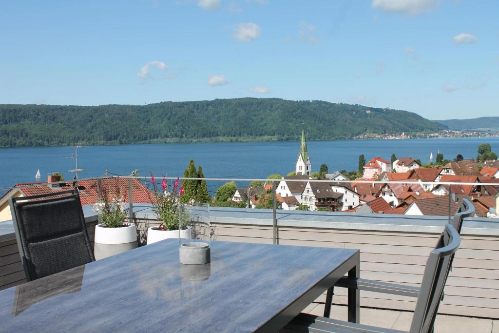 uma mesa numa varanda com vista para a água em REBHAUS Ferienwohnung Weinlaube em Sipplingen