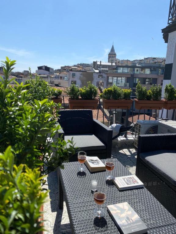a patio with two tables and two glasses of wine at Galata VAV Suites in Istanbul
