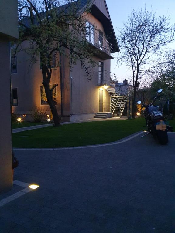 a motorcycle parked in front of a house at Johnny House in Suwałki