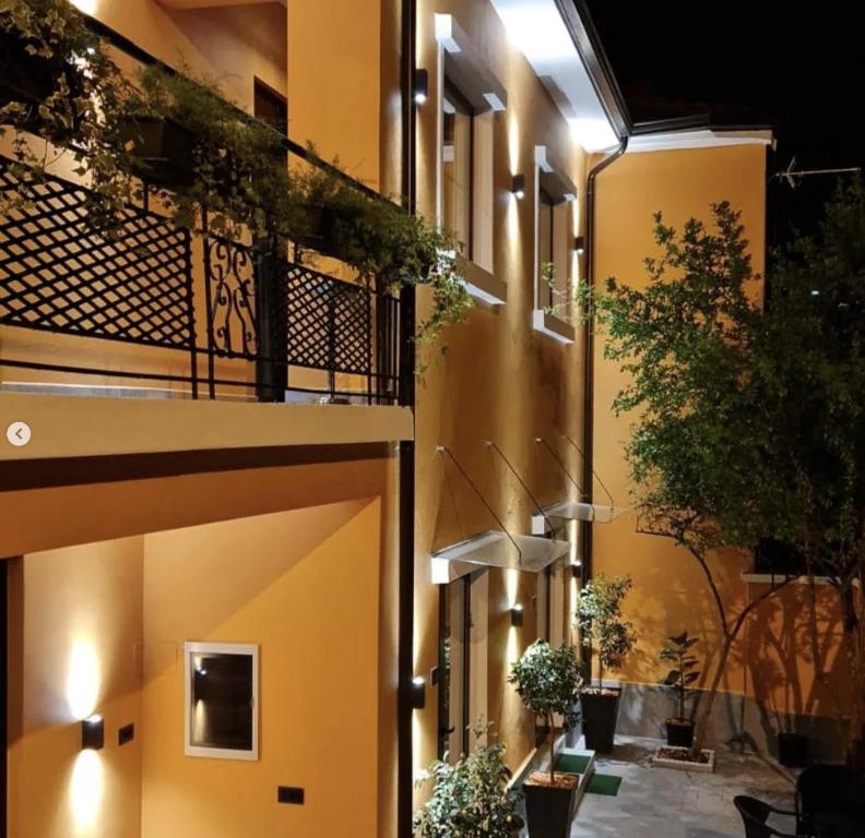 a building with a balcony with plants on it at Vila Jasmine in Tirana