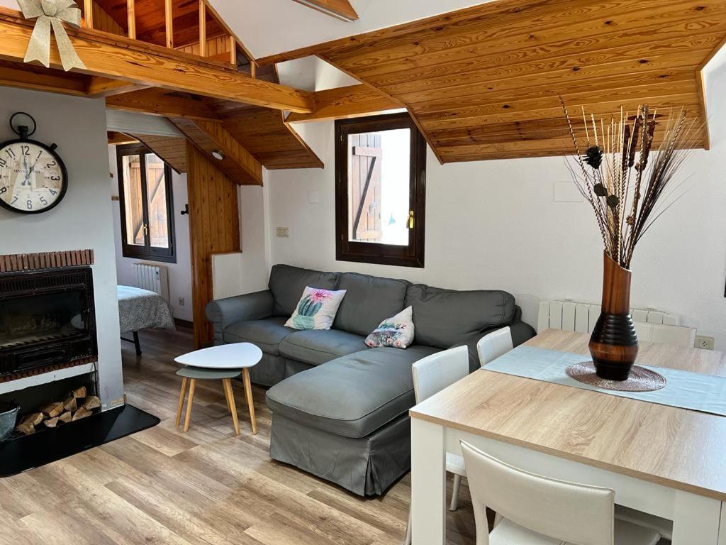 a living room with a couch and a table at Casa Lita in Panticosa