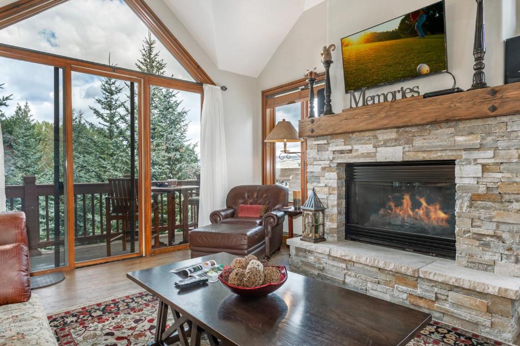 a living room with a fireplace and a table at A6 Village Townhouse in Edwards