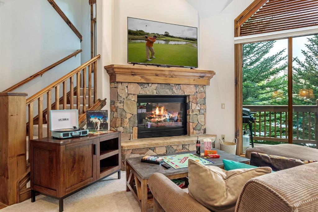 a living room with a fireplace with a tv above it at E1 Village Townhouse in Edwards