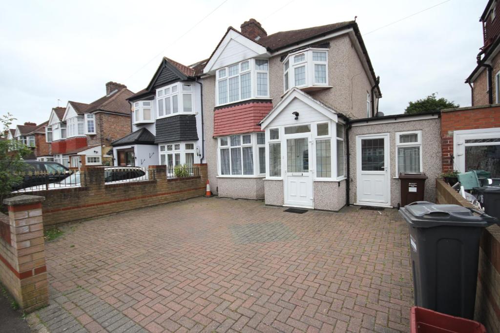 a brick driveway in front of a house at Feltham House in Feltham