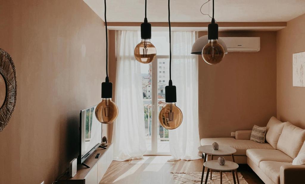 a living room with a couch and a window at S t r e h ë z a in Tirana