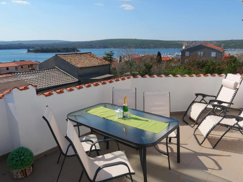 patio ze stołem i krzesłami na balkonie w obiekcie Apartment Barbara-2 by Interhome w mieście Punat