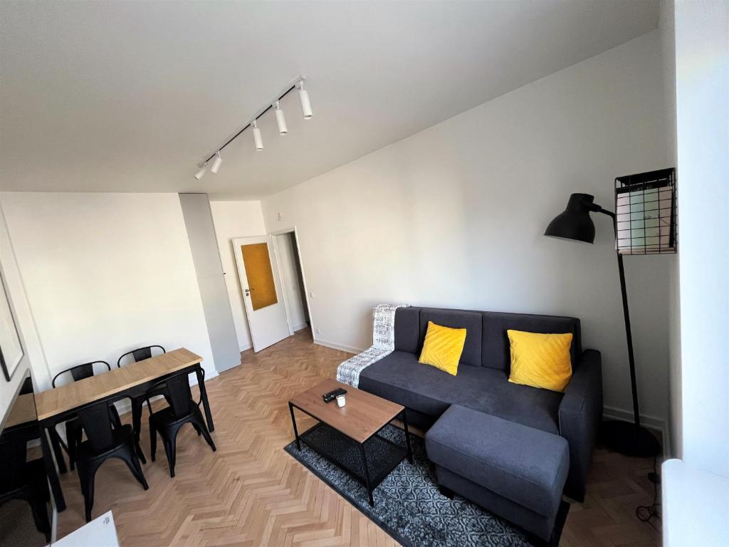 a living room with a couch and a table at Apartament RZ in Gdynia