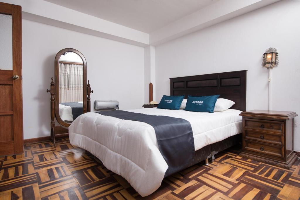 En eller flere senger på et rom på Ayenda Casa Escondida San Cristóbal Premium