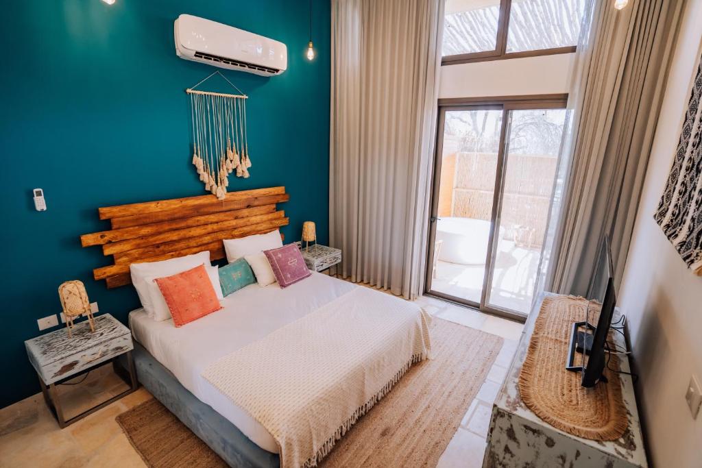 米茨佩·拉蒙的住宿－Selina Desert Garden Ramon，一间卧室设有一张床和蓝色的墙壁