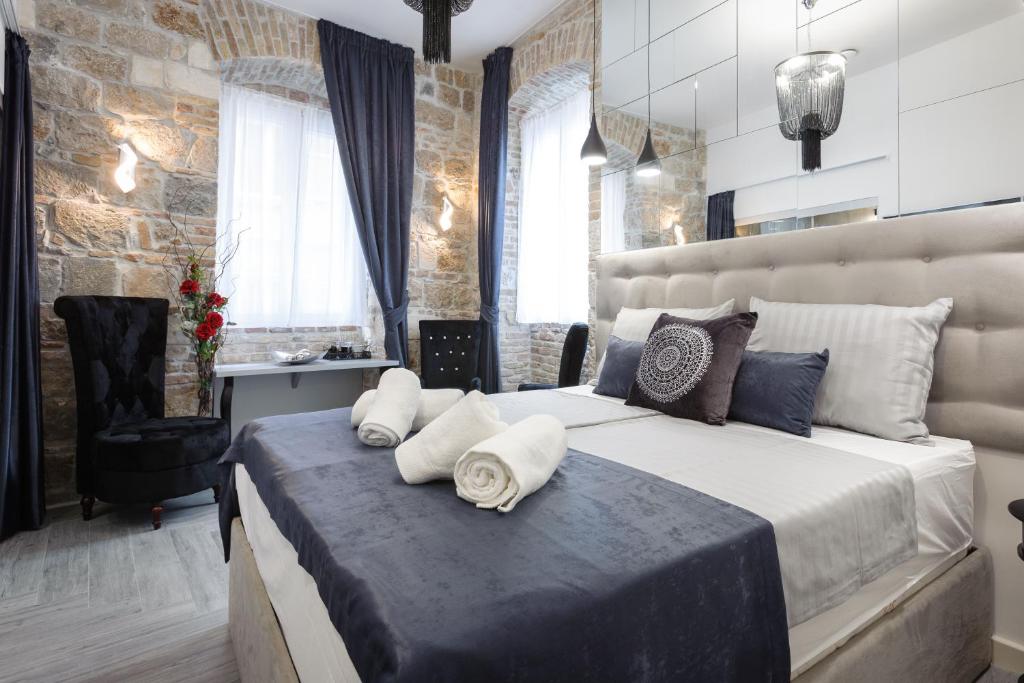 a bedroom with a large bed with pillows on it at Marie Rooms Centar Split in Split
