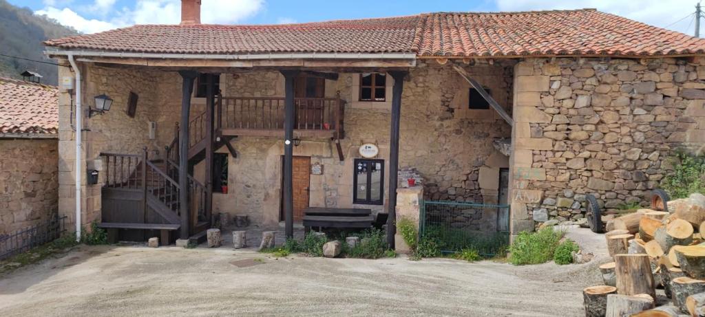 a stone house with a porch and a balcony at La Posada de la Valuisilla - Bed&Breakfast in Cicera