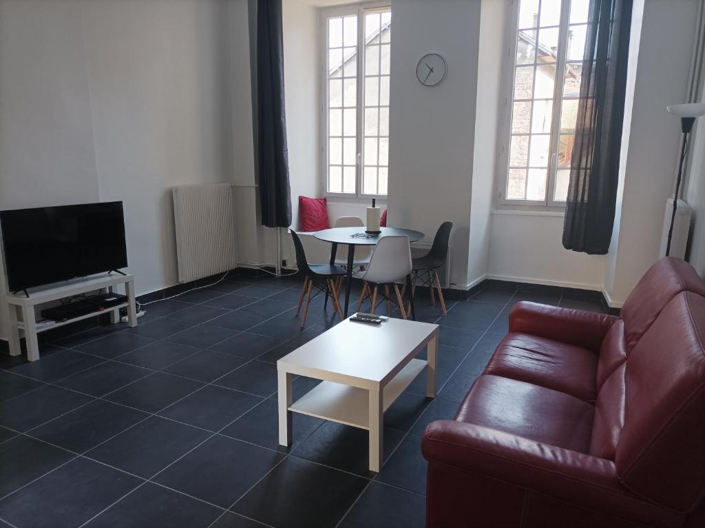 a living room with a couch and a table at O'Couvent - Appartement 73 m2 - 2 chambres - A311 in Salins-les-Bains