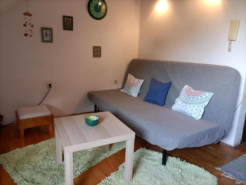 a living room with a couch and a table at Apartman Lara in Belgrade