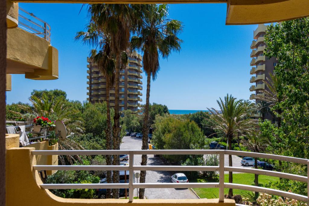 a balcony with a view of the beach and buildings at Salamar Saler Golf in El Saler