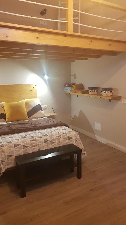 a bedroom with a bed with a wooden bed frame at EL PISITO DEL TABLERO in Erjos
