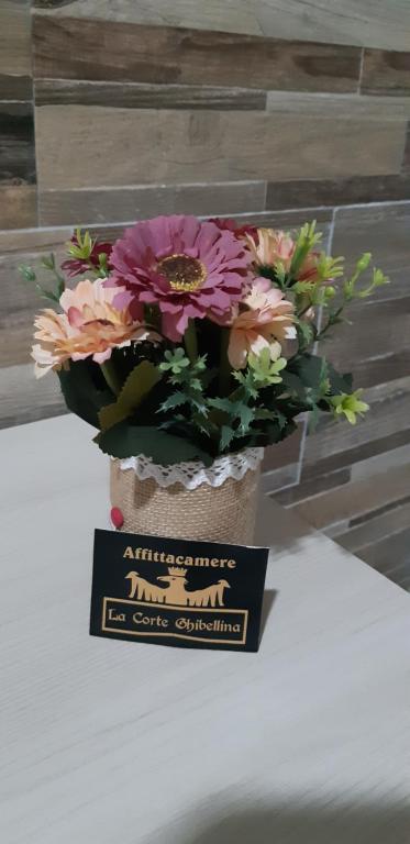 a bouquet of flowers in a trophy on a table at Domos La Corte Ghibellina in Iglesias