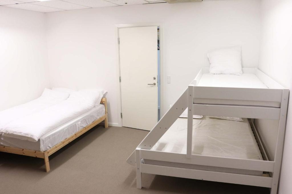 Voodi või voodid majutusasutuse Budget Rooms Copenhagen toas