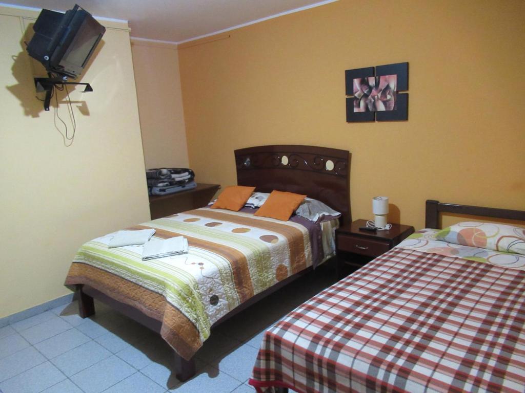 Postel nebo postele na pokoji v ubytování Kurmi Hostel Lima Airport