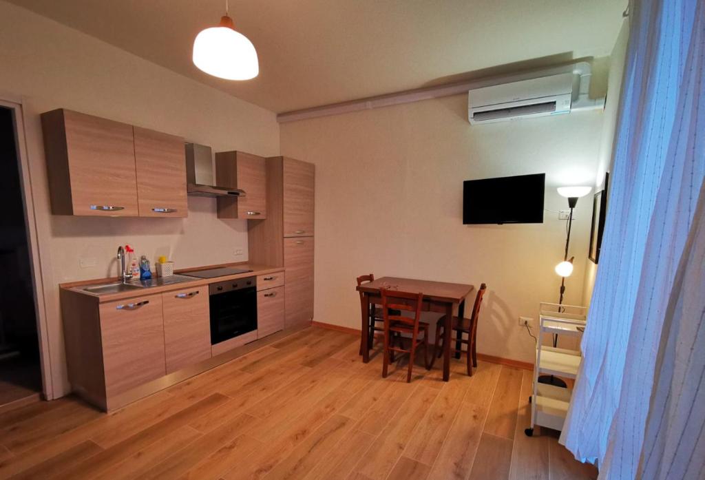 a kitchen with a table and a dining room at Casa Noa in Crema