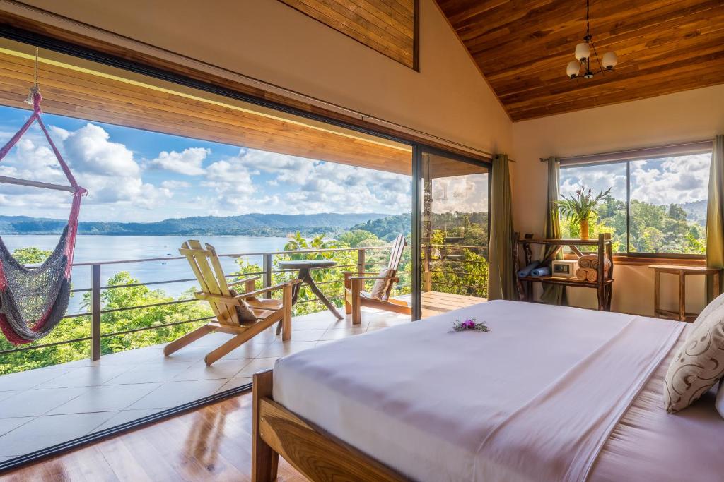 a bedroom with a bed and a large window at Drake Bay Getaway Resort in Drake
