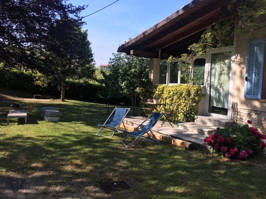 two chairs sitting in the grass outside of a house at CASA IL GLICINE in Rocchetta Palafea