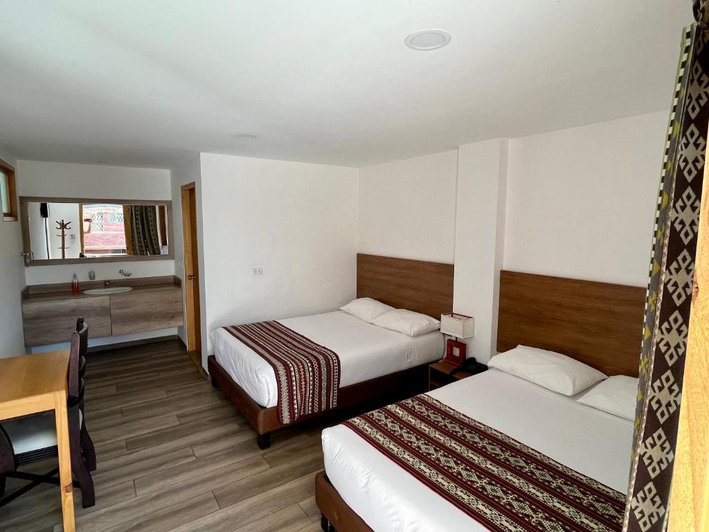 Postel nebo postele na pokoji v ubytování Hotel El Geranio