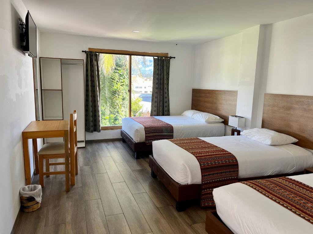 Postel nebo postele na pokoji v ubytování Hotel El Geranio