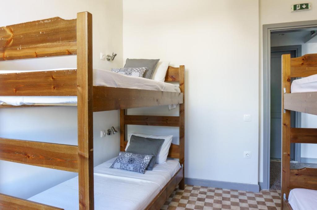 
a bunk bed with two bunk beds in a room at Dioskouros Hostel in Athens
