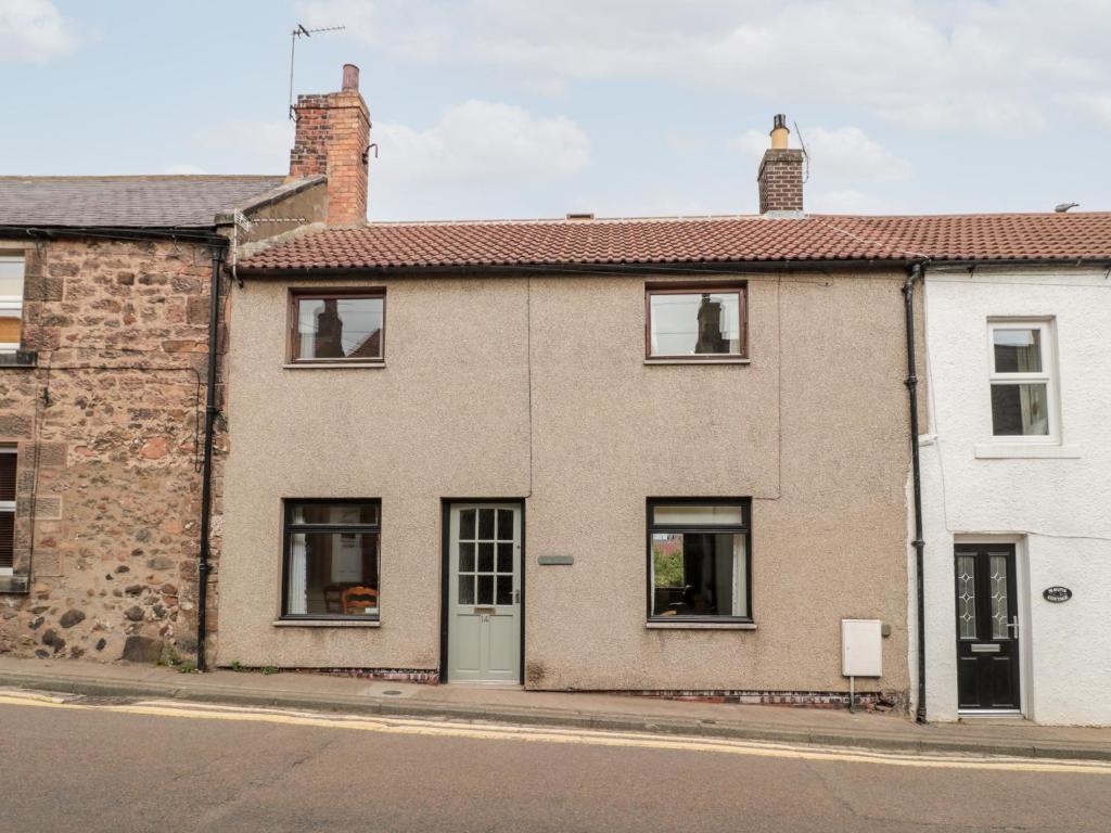 a brick house on the side of a street at York Cottage in Wooler