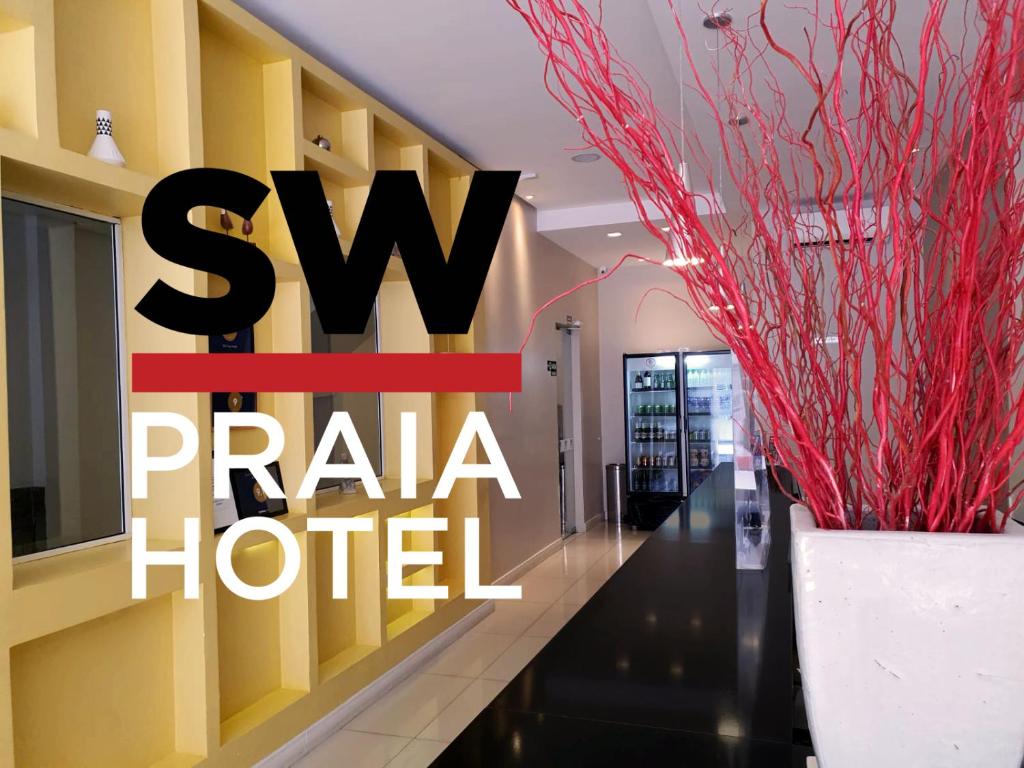 a hotel lobby with a sign that reads sw parla hotel at SW Praia Hotel in Praia Grande