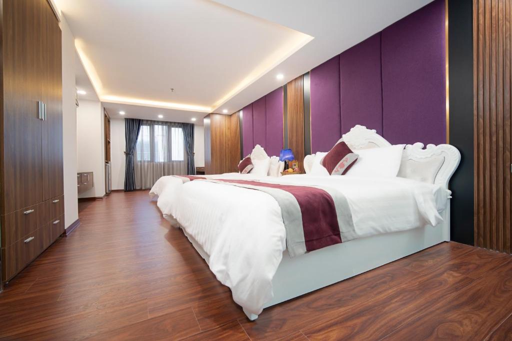 Postel nebo postele na pokoji v ubytování Le Indochina Hotel & Beach Da Nang City