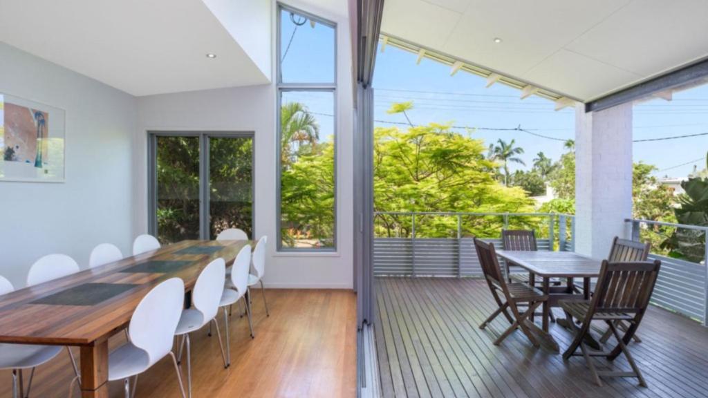 a dining room with a table and chairs at Moffat Retreat, Moffat Beach in Caloundra