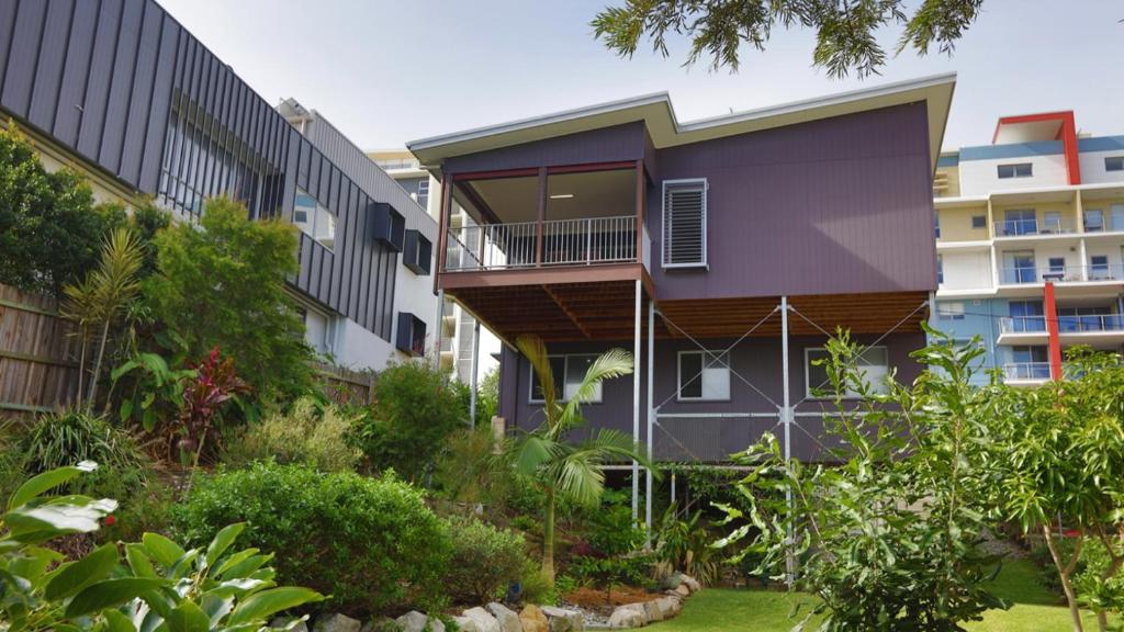 an apartment building with a garden in front of it at Saltys Place, Pet Friendly and Close To Beach in Caloundra