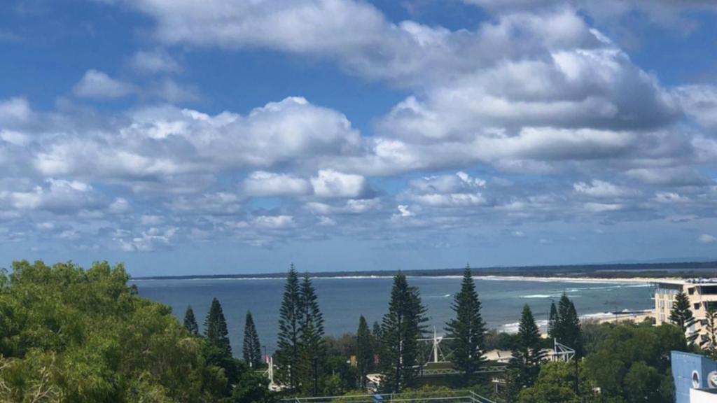 a view of a beach and the ocean under a cloudy sky at Coastal Apt At Kings Beach, Stunning View in Caloundra