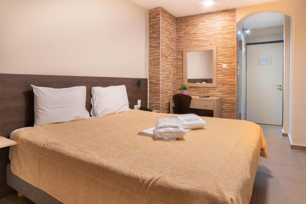 a bedroom with a large bed in a room at Anita Hotel in Piraeus