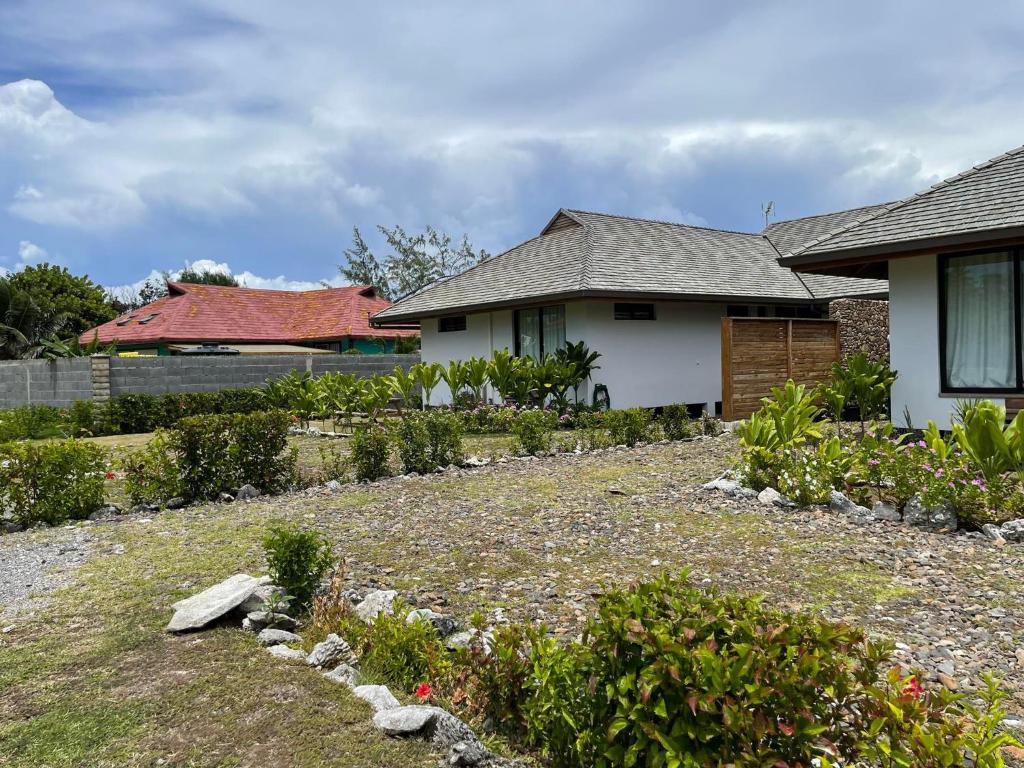 a house with a garden in front of a house at Moorea Lodge in Temae