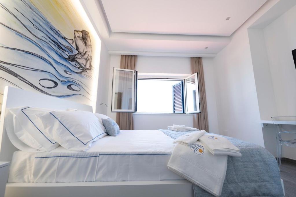 Postel nebo postele na pokoji v ubytování Mbaccimari B&B