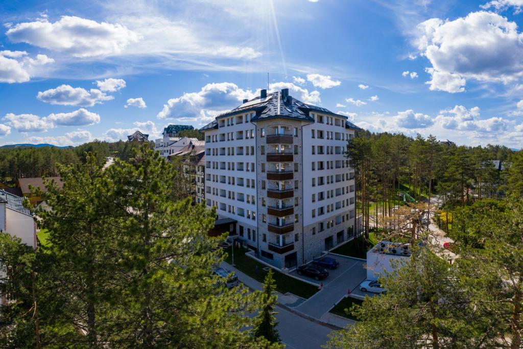 an overhead view of a tall white building at Konak Apartmani & SPA in Zlatibor