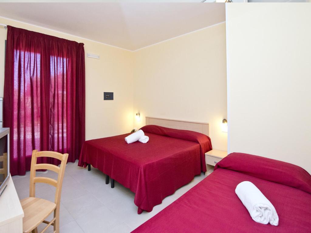 Postel nebo postele na pokoji v ubytování Hotel Club Koiné