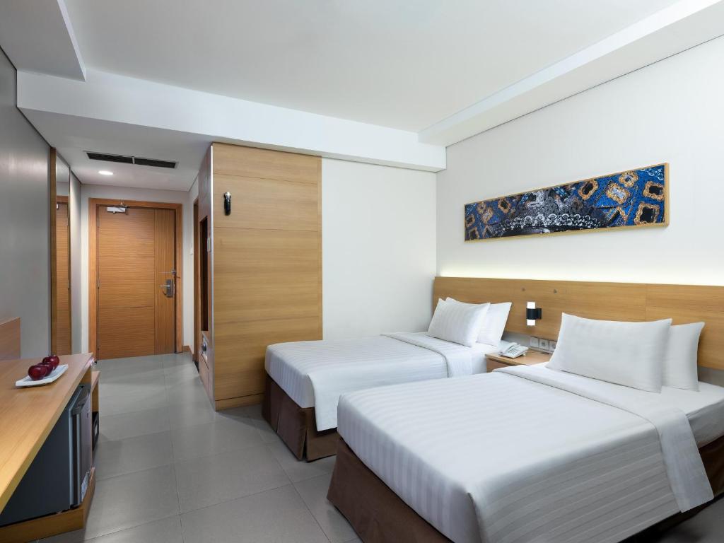 Postel nebo postele na pokoji v ubytování Aston Solo Hotel