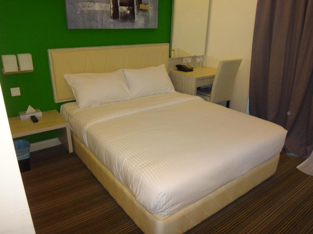 Tempat tidur dalam kamar di Kosma Business Hotel