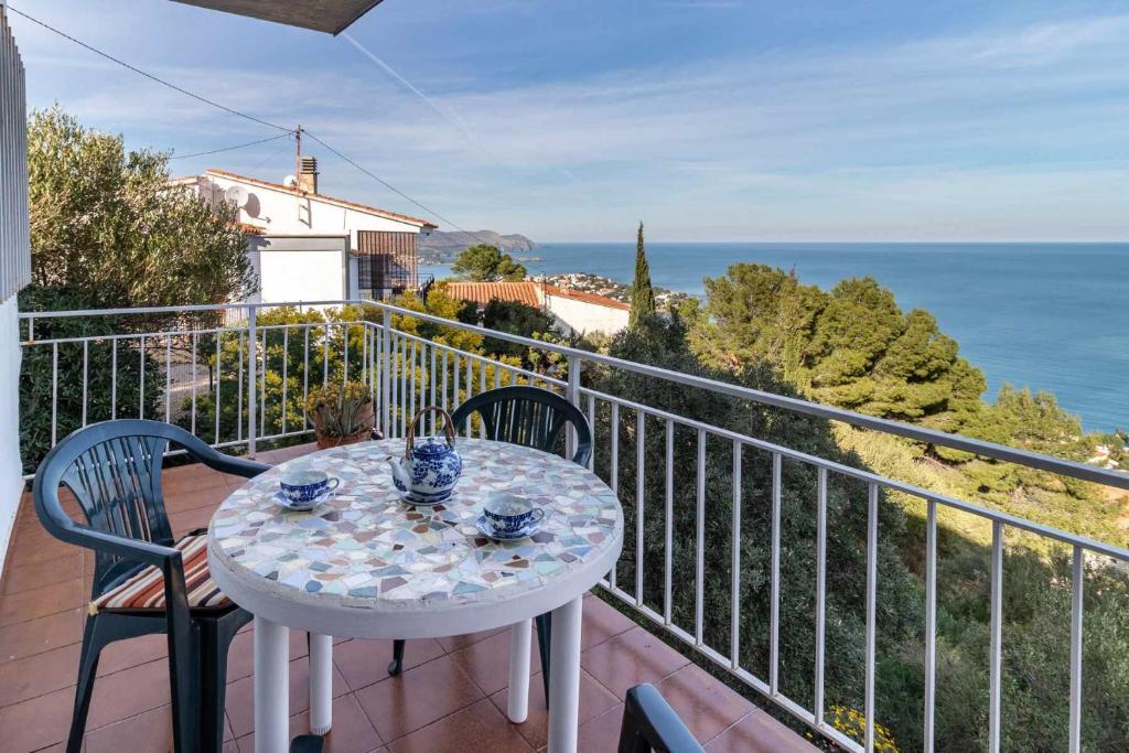a table on a balcony with a view of the ocean at Super Fener 93 ático con terraza y vistas in Girona
