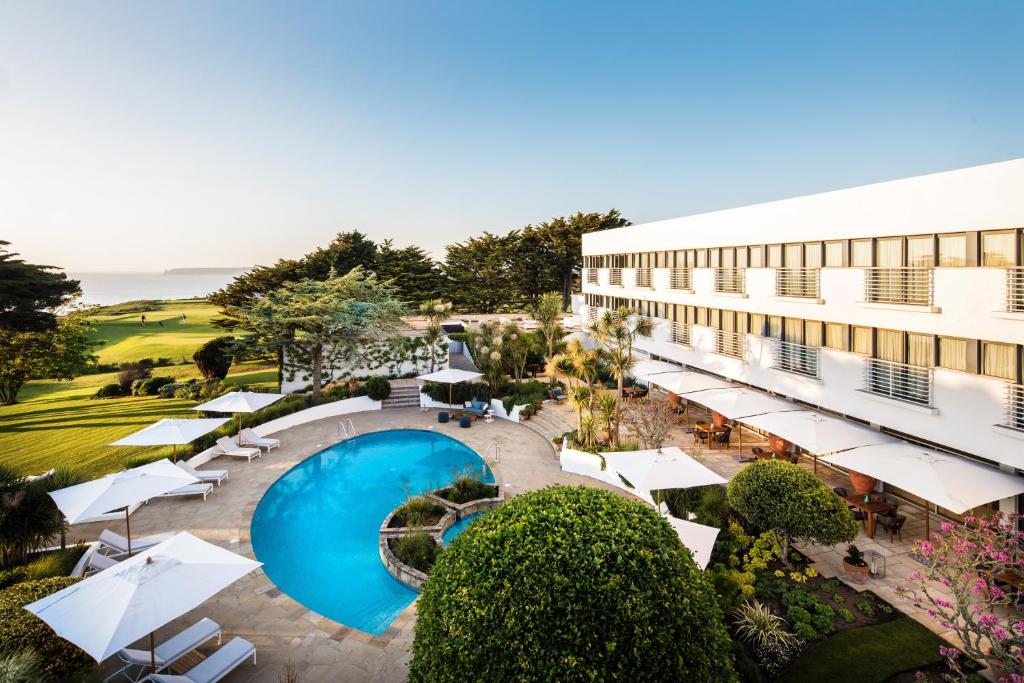 an overhead view of a resort with a pool and umbrellas at The Atlantic Hotel - Small Luxury Hotels of the World in St Brelade