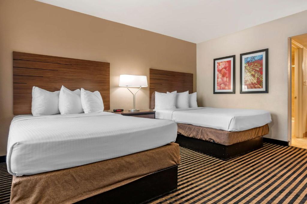 a hotel room with two beds and two lamps at Best Western Town House Lodge in Modesto