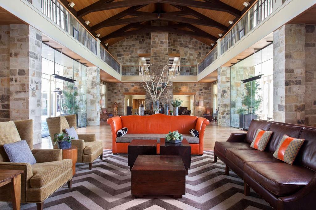 a lobby with a couch and chairs and a table at Hyatt Regency Lost Pines Resort and Spa in Cedar Creek