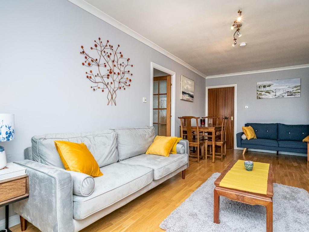 a living room with a couch and a table at Pass the Keys Stunning Flat with Sea View and Parking in Edinburgh