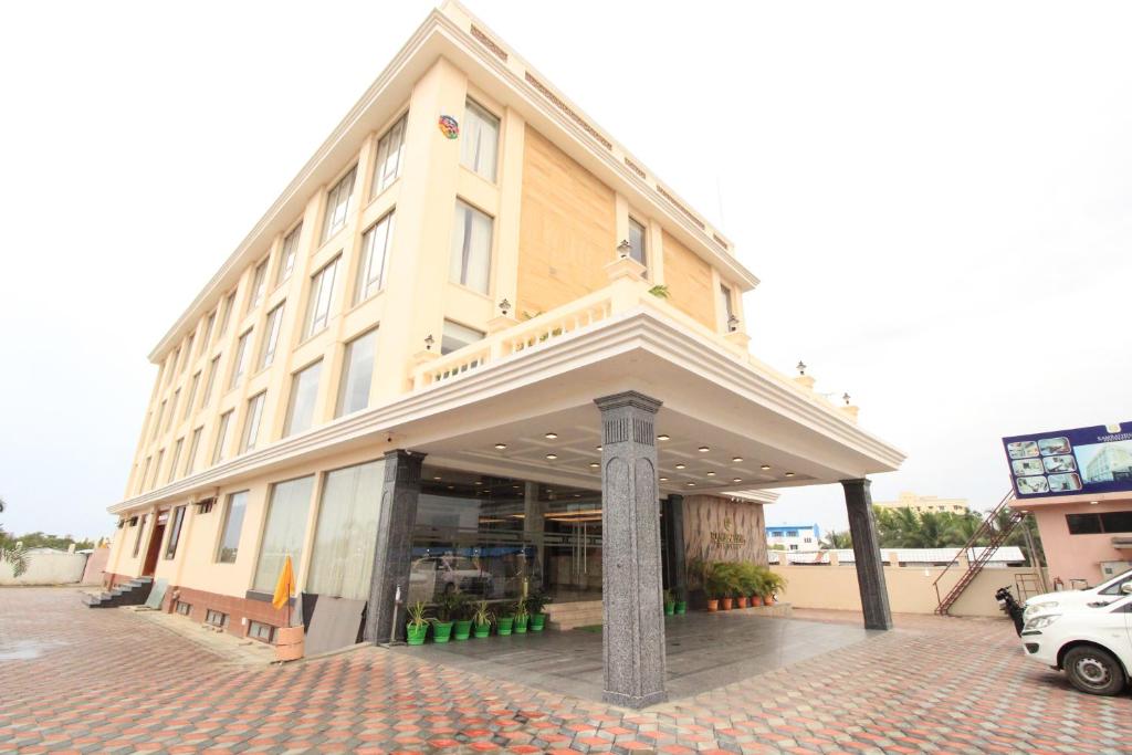 a building on a street with a car parked in front at RAMRATHNA RESIDENCY in Madurai
