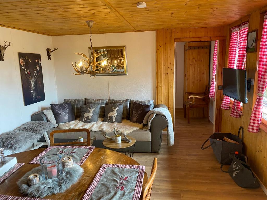 sala de estar con sofá y mesa en Hütte für Naturliebhaber - Kinder/ Ponyreiten, en Zella-Mehlis