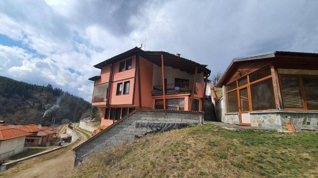 a house sitting on top of a hill at Вила Родопи in Dospat